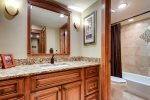 Guest bathroom with tub/shower combination, and pocket door for added privacy and convenience getting ready in the morning